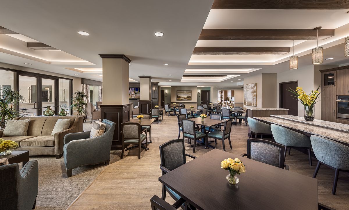 A modern and spacious dining area with elegant furnishings and ambient lighting.