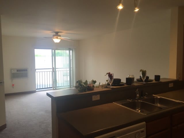 Open-plan kitchen and living room with a balcony view.