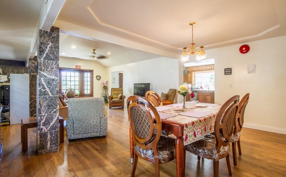 A cozy and inviting living and dining area with wooden flooring and elegant furniture.