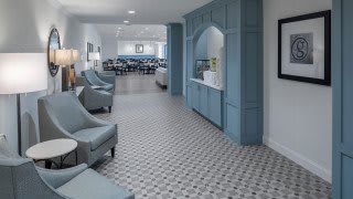 A modern lobby with comfortable seating and decorative tiled flooring.