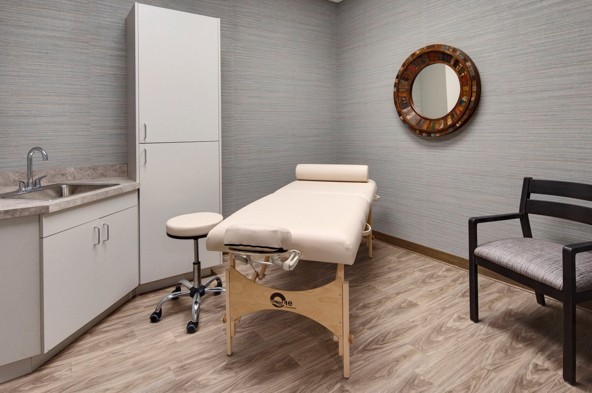 A tranquil massage room featuring a comfortable treatment table and modern decor.