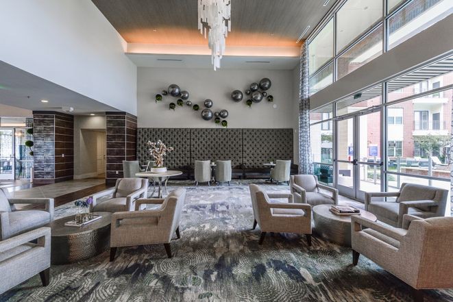 A modern hotel lobby with elegant seating and decorative wall art.