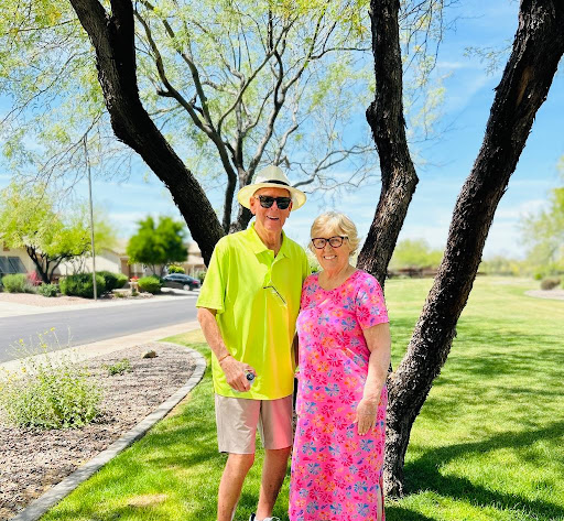 A cheerful couple enjoying a sunny day in the park.
