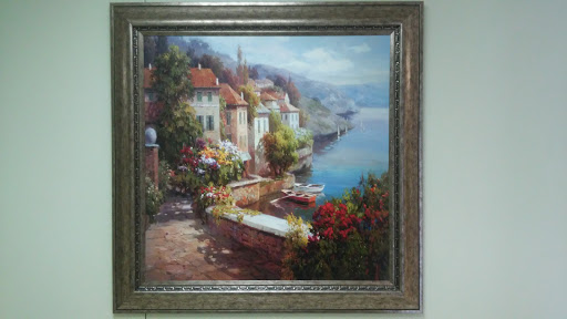 A tranquil waterfront scene showcasing charming houses surrounded by colorful flowers, set against a picturesque backdrop.