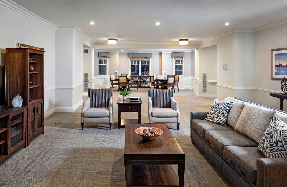 A modern living room with comfortable seating, elegant furnishings, and soft lighting.