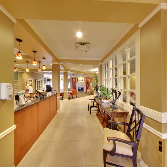 A warm and inviting restaurant interior with a seating area and decorative lighting.