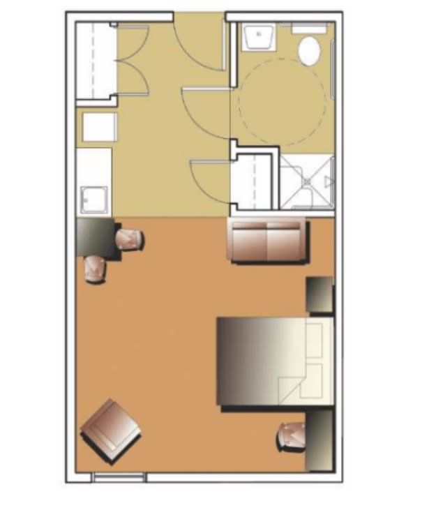 This is a floor plan of a compact studio apartment, featuring a living area, kitchen, bathroom, and sleeping space.