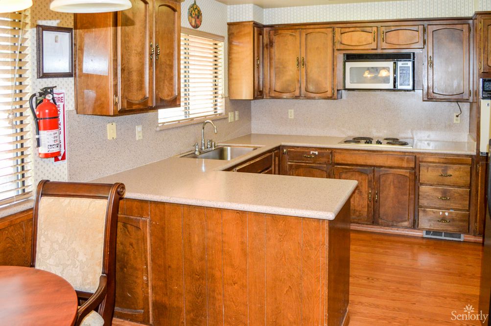 A cozy kitchen with wooden cabinets and modern appliances.