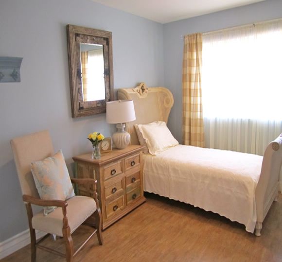 A cozy bedroom with a single bed and traditional furnishings.