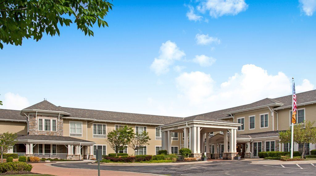 A hotel building with a grand entrance and clear blue sky.