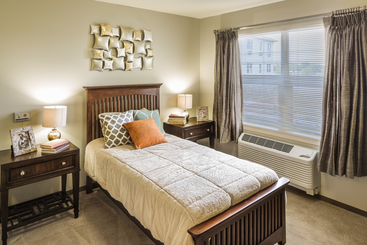 A cozy bedroom with a single bed, modern decor, and abundant natural light.