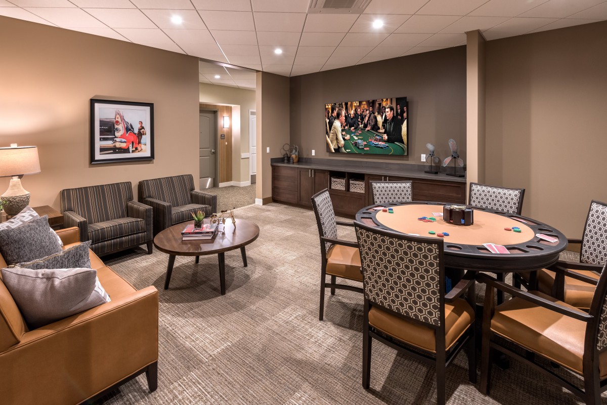 A modern lounge area with comfortable seating and a conference table.