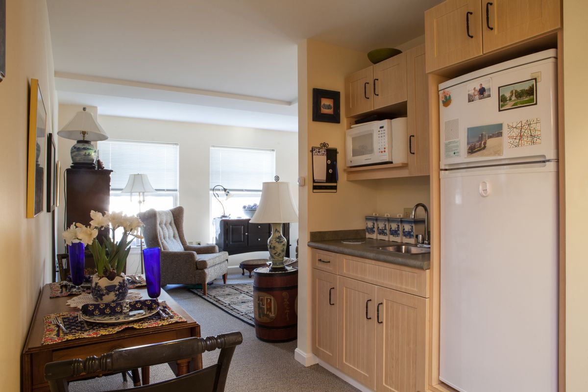 Cozy living and kitchen area with modern appliances and comfortable seating.