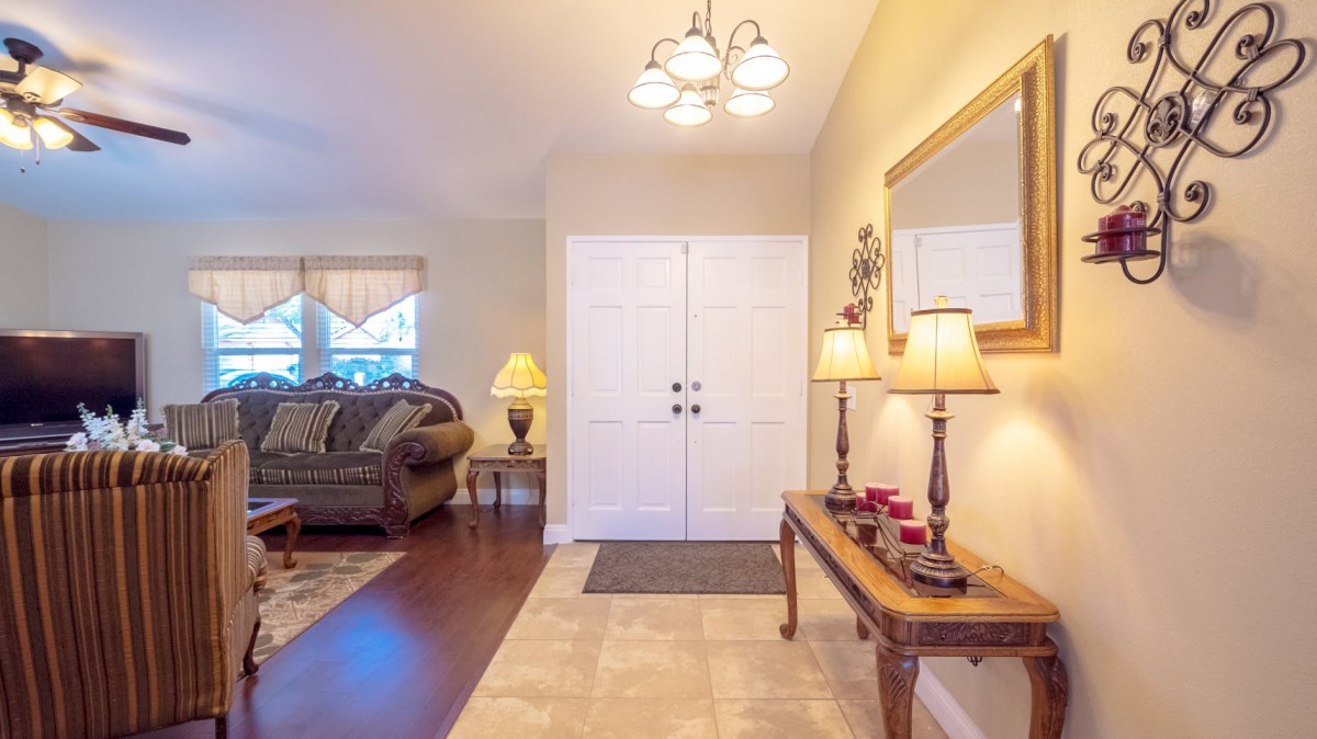 A cozy living room entryway featuring elegant decor and warm lighting.
