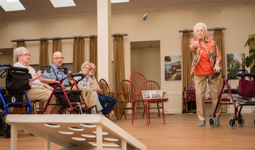 A group of elderly individuals engaged in an indoor activity.