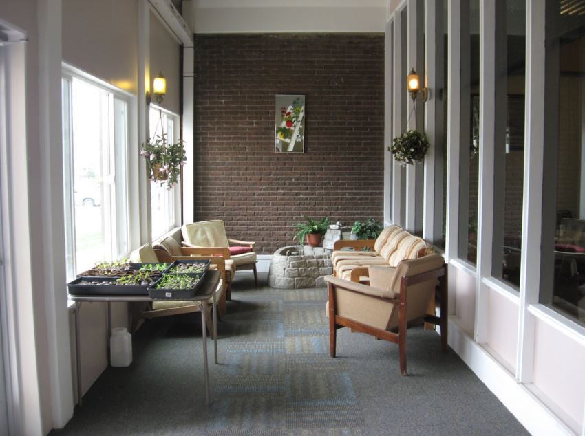 A cozy indoor lounge area with comfortable seating and plants.