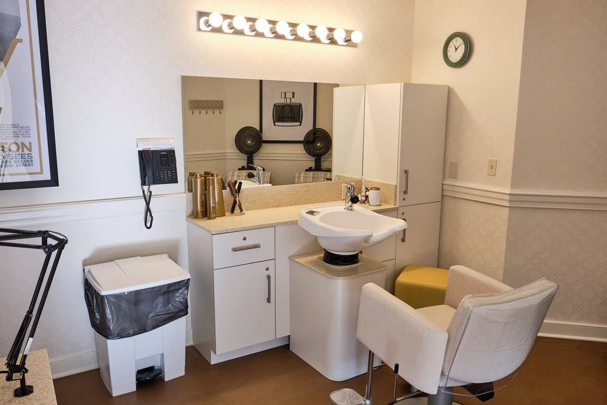 A small, well-organized hair salon with a washing station and styling area.