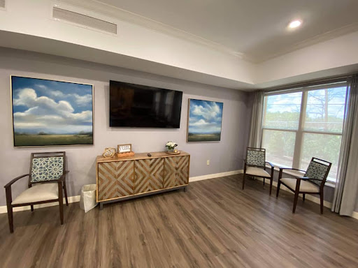 A cozy living room featuring modern decor, wall art, and a television.