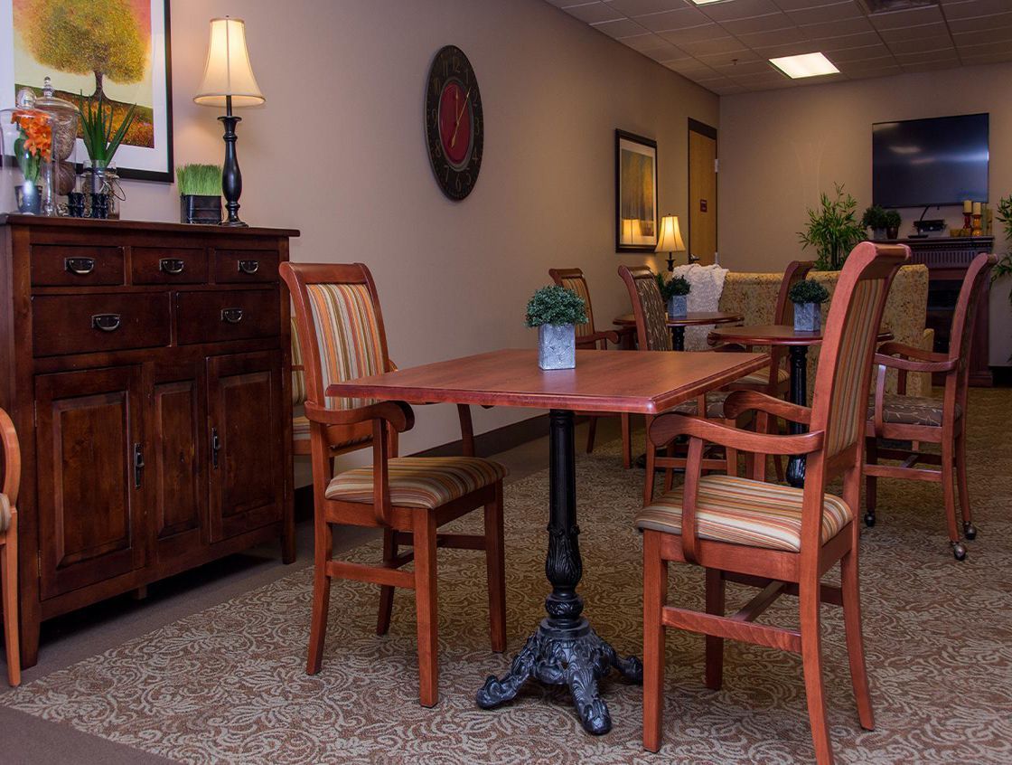 A cozy dining area with wooden furniture and decorative elements.