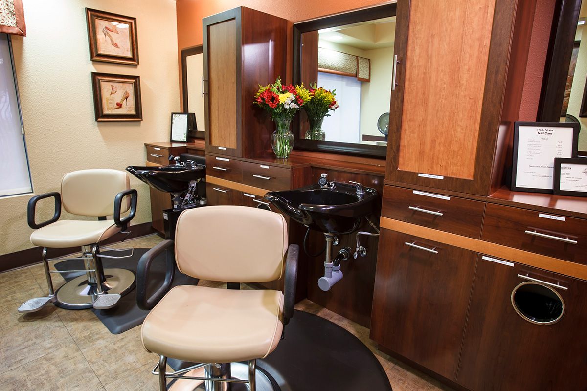 A well-equipped hair salon with chairs and mirrors, ready for clients.