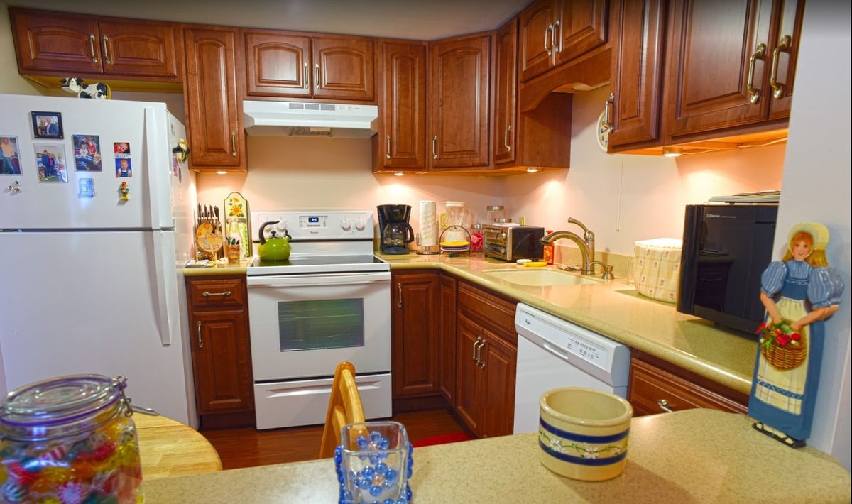 A cozy kitchen with wooden cabinets and modern appliances.