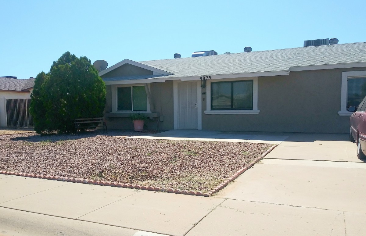 A single-story suburban house with a dry landscape front yard and driveway.