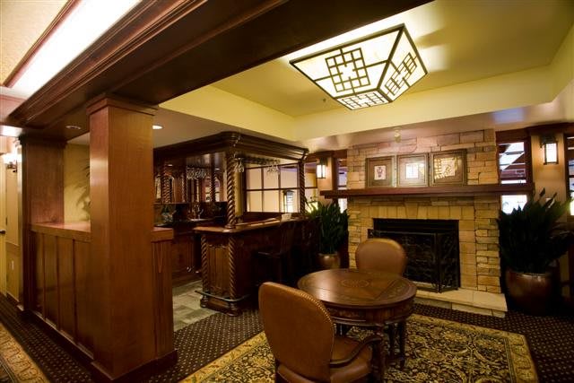 A cozy interior space with wooden furnishings and a fireplace.