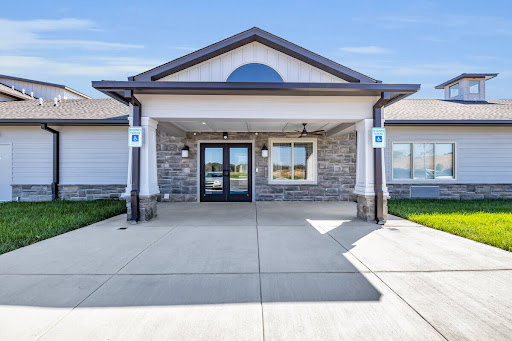 A modern building entrance with stone accents and a welcoming facade.