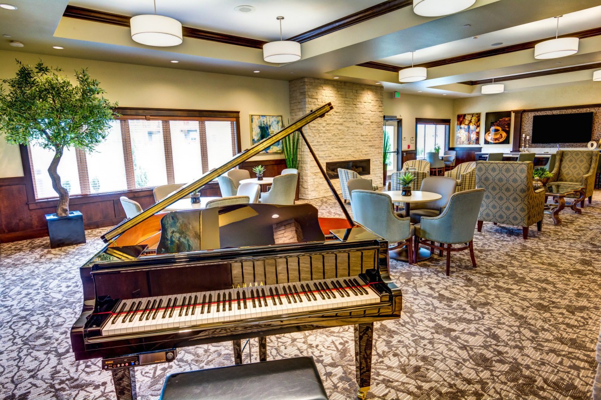 A cozy lounge area with a grand piano and elegant seating arrangements.
