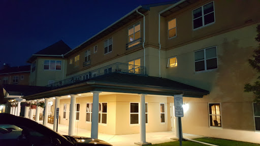 A view of a modern building illuminated at night.