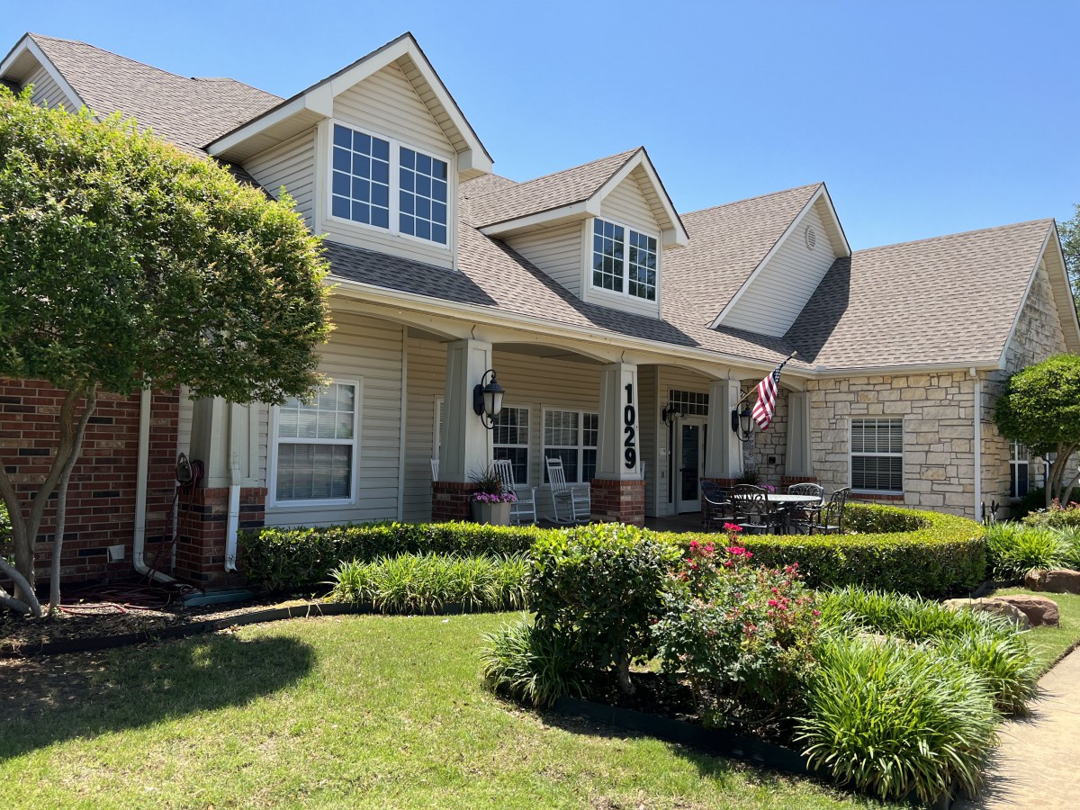 A picturesque suburban house with a well-maintained lawn and garden.