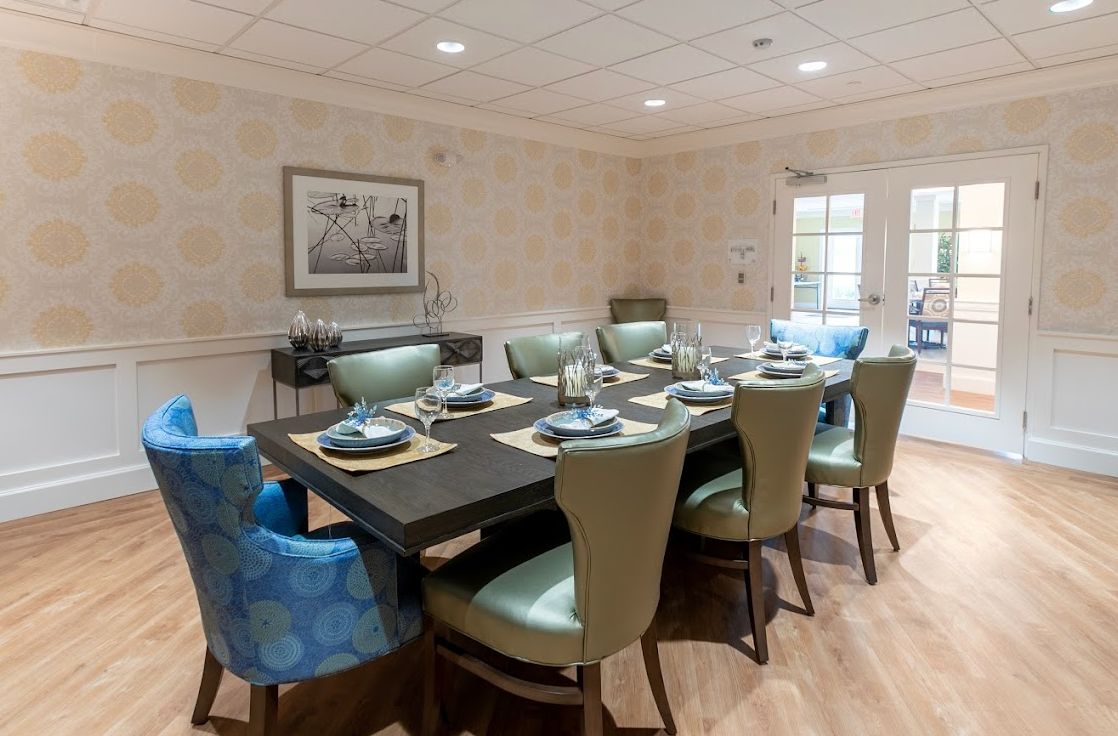 A well-decorated dining room with a large table set for a meal.
