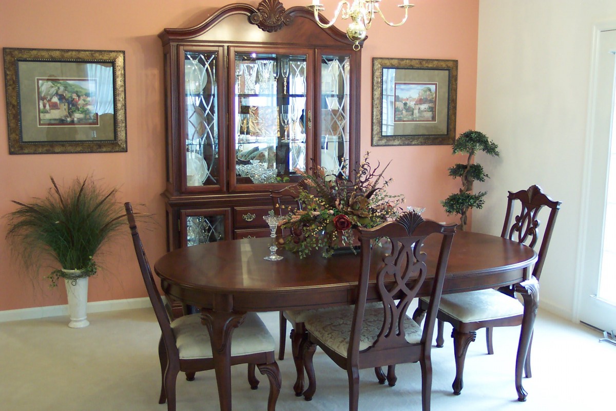 A traditional dining room with ornate furniture and elegant decor.