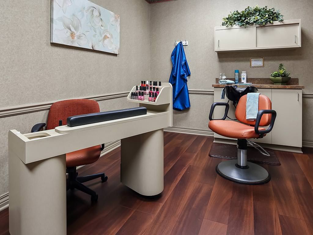 A professional office space with a desk, chairs, and wall decor.