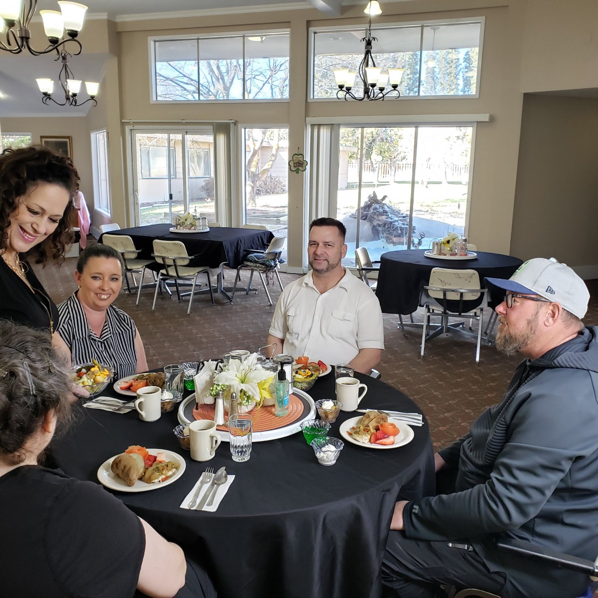 A group of people enjoying a casual meal together indoors.