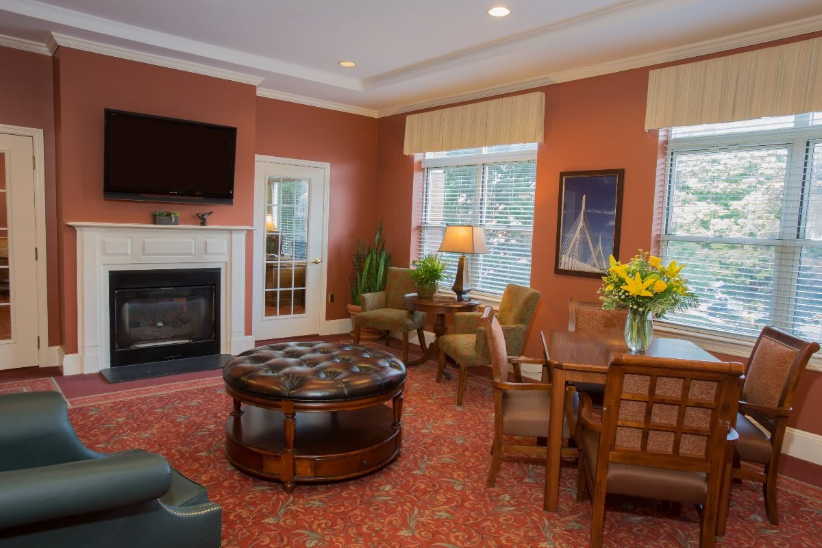 A cozy living room with a fireplace, television, and comfortable seating.