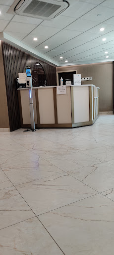 A modern reception area with a sleek counter and elegant flooring.
