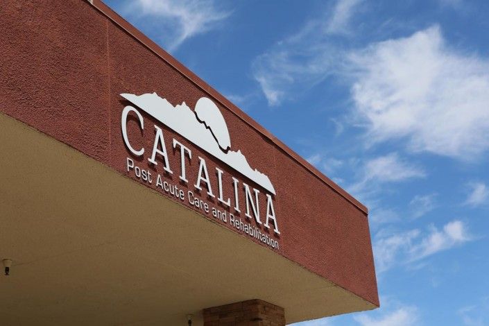 A building with a sign that reads 'Catalina' against a clear blue sky.