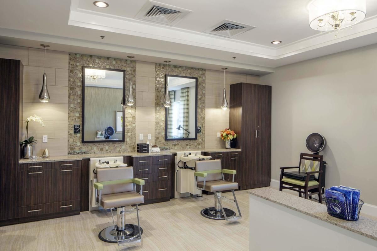 A modern salon interior with styling chairs and mirrors.