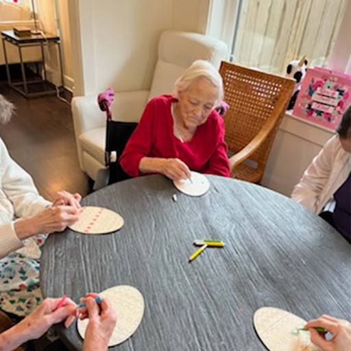 Seniors engaged in a creative crafting session together.
