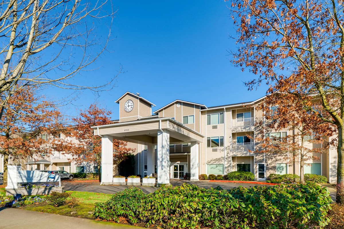A view of a retirement home with a prominent entrance and well-maintained landscaping.