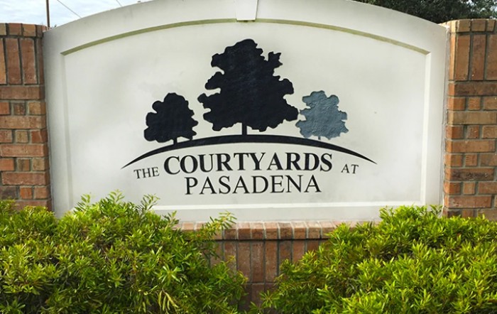 Entrance sign for The Courtyards at Pasadena residential area.
