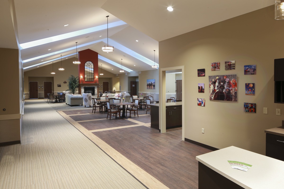 A modern, open-concept dining area with skylights and contemporary furniture.