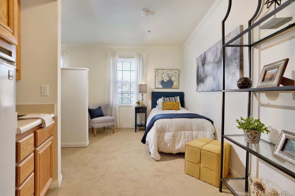 A cozy and modern bedroom with a single bed, soft furnishings, and tasteful decor.