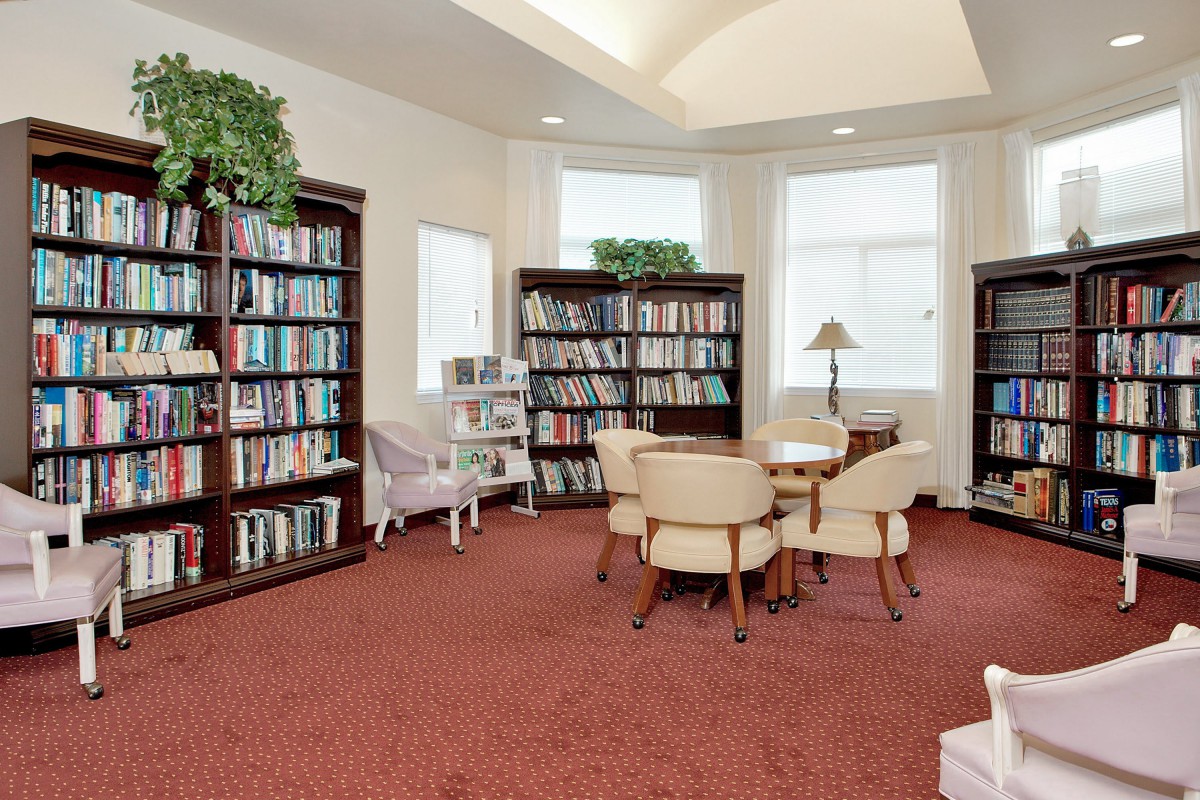 A cozy library reading area with bookshelves and comfortable seating.