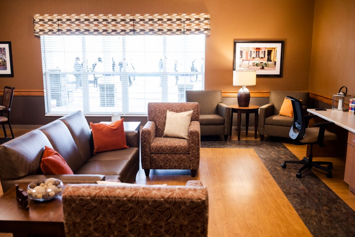 A cozy living room with comfortable seating and warm lighting.