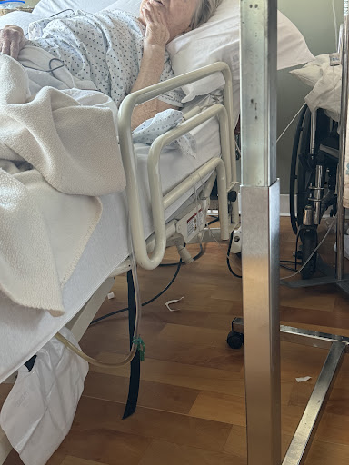 A close-up view of a hospital bed and surrounding medical equipment.