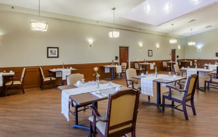 An elegant dining room setup with neatly arranged tables and chairs.