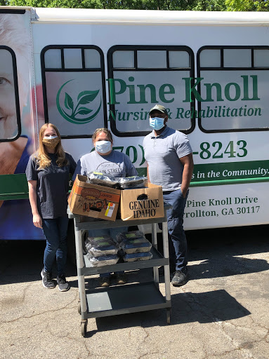 Volunteers from Pine Knoll Rehabilitation participate in a community food donation event.
