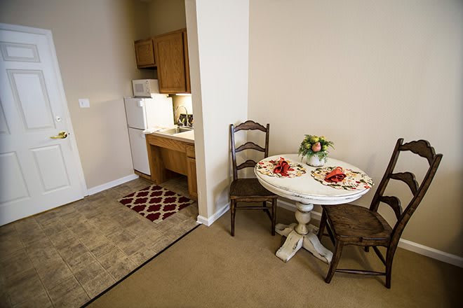 Cozy kitchen and dining area in an apartment with a small table set for two.